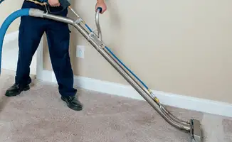 Professional operating a liquid removal machine on a carpeted floor in Charleston, SC